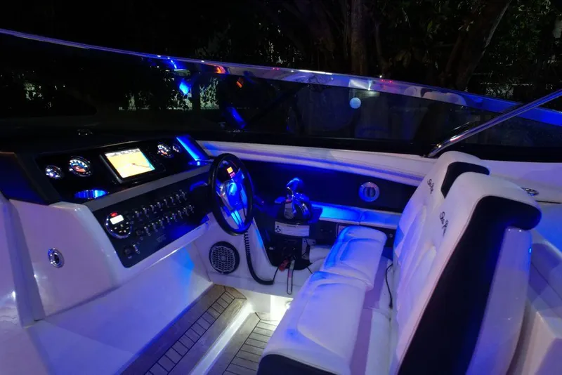 Slide: The Image of Luxurious 2015 Sea Ray 350 SLX boat interior with illuminated dashboard and plush seating. - 9
