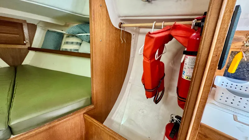 Slide: The Image of Interior of a 1970 CAL 29 sailboat with life jackets and fire extinguisher. - 15