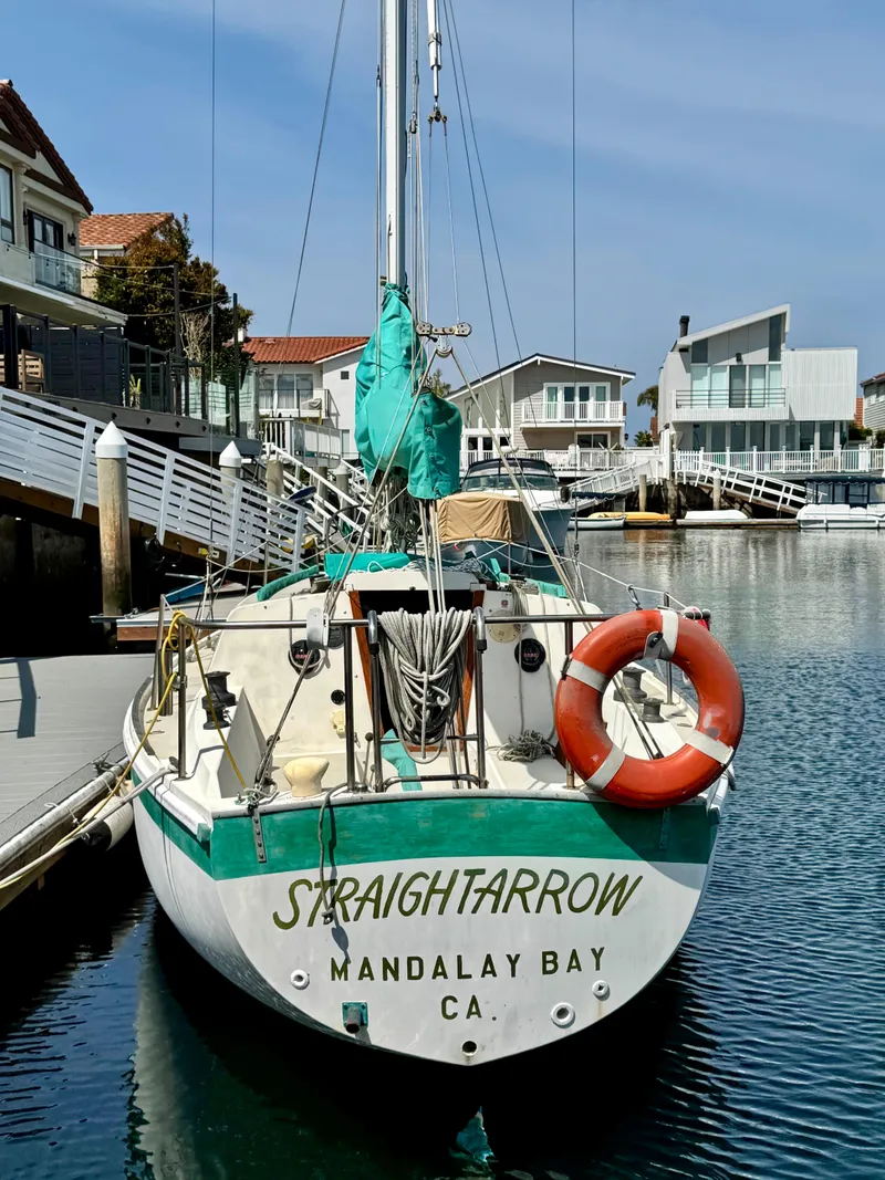Slide: The Image of 1970 CAL 29 sailboat docked at Mandalay Bay, CA, with lifebuoy and nautical equipment. - 2
