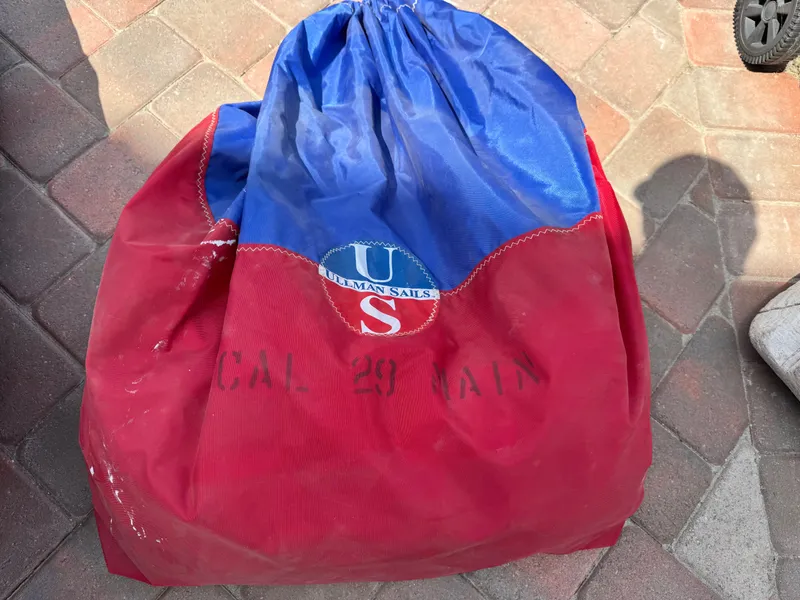 Slide: The Image of Red and blue sail bag with "US Ullman Sails" logo, on a brick surface. - 21