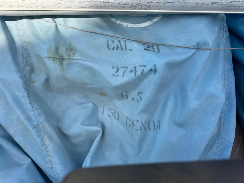 Slide: The Image of Blue sail with "CAL 29" and numbers, indicating a 1970 CAL 29 sailboat. - 27