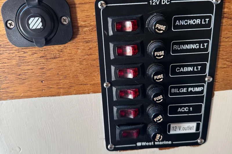 Slide: The Image of 12V DC marine switch panel with fuses for anchor, running, cabin lights, and bilge pump. - 30