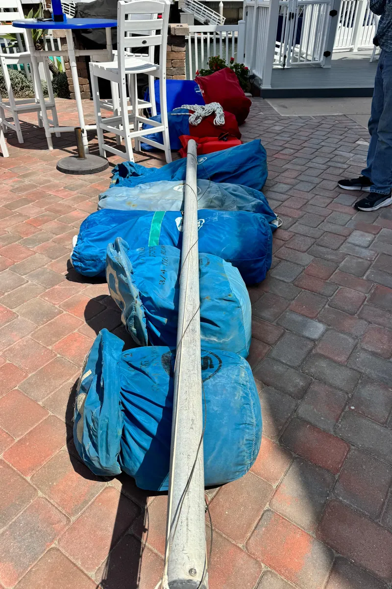 Slide: The Image of Sailboat mast and sails from a 1970 CAL 29 on a brick patio. - 31