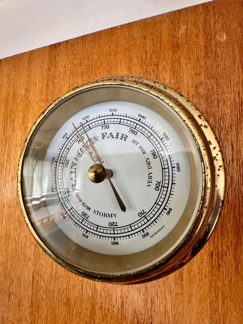 Slide: The Image of Vintage 1970 CAL 29 barometer with brass casing on wooden surface. - 5