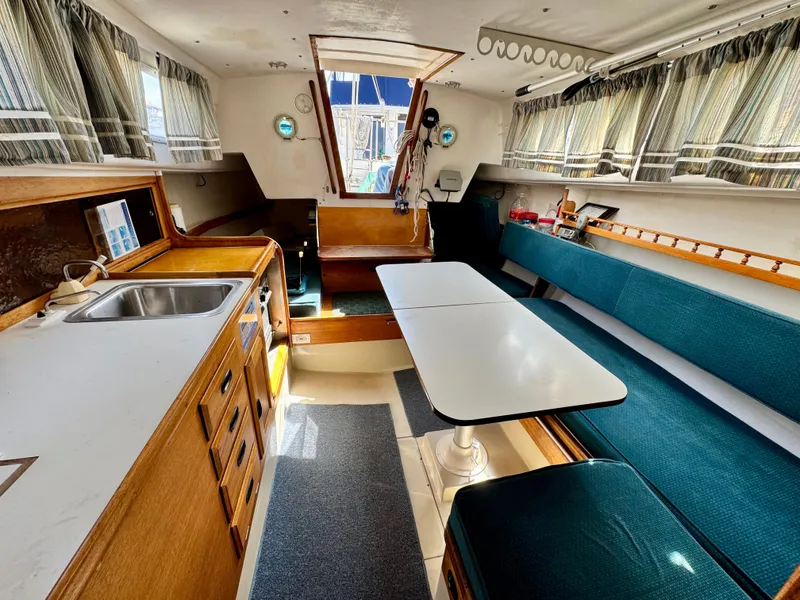 Slide: The Image of Interior of a 1970 CAL 29 sailboat with kitchen and seating area. - 6