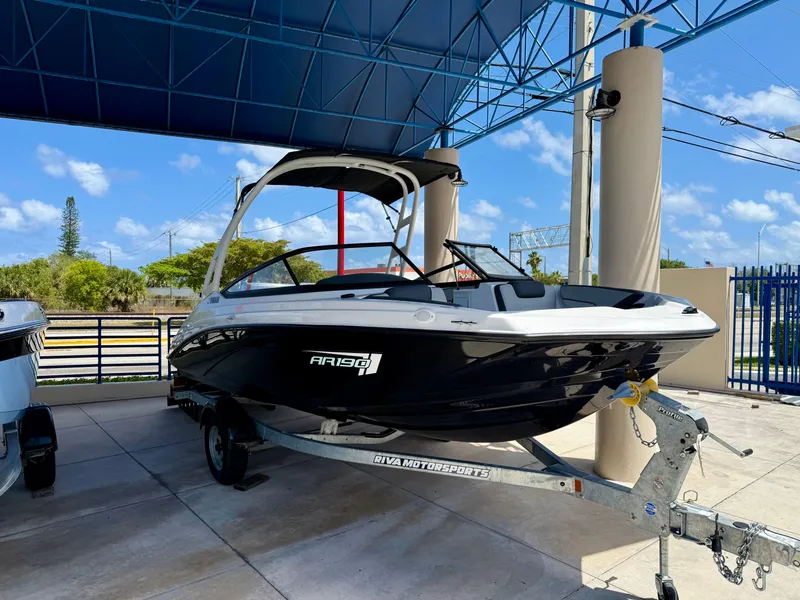 The Image of 2025 Yamaha AR190 boat on trailer under blue canopy, sunny day. - 0