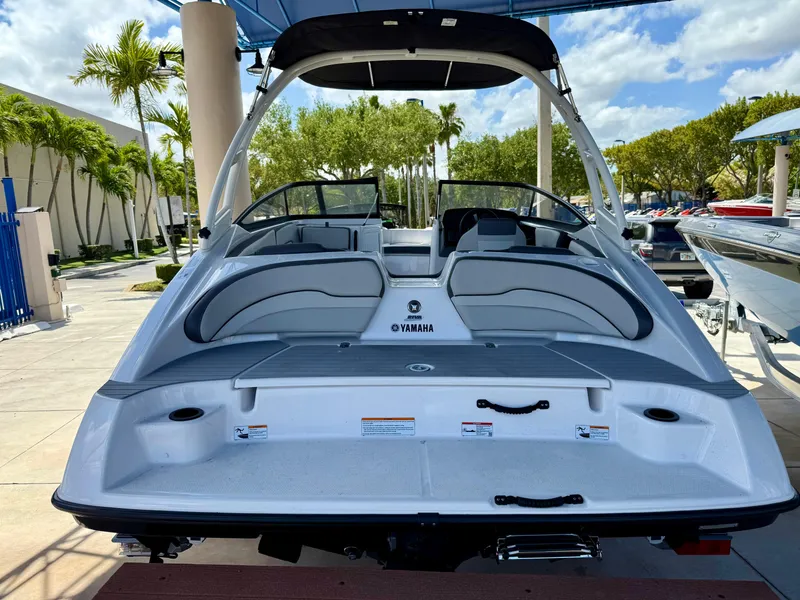 Slide: The Image of 2025 Yamaha Boats AR190, sleek design, spacious seating, outdoor display, sunny day. - 1