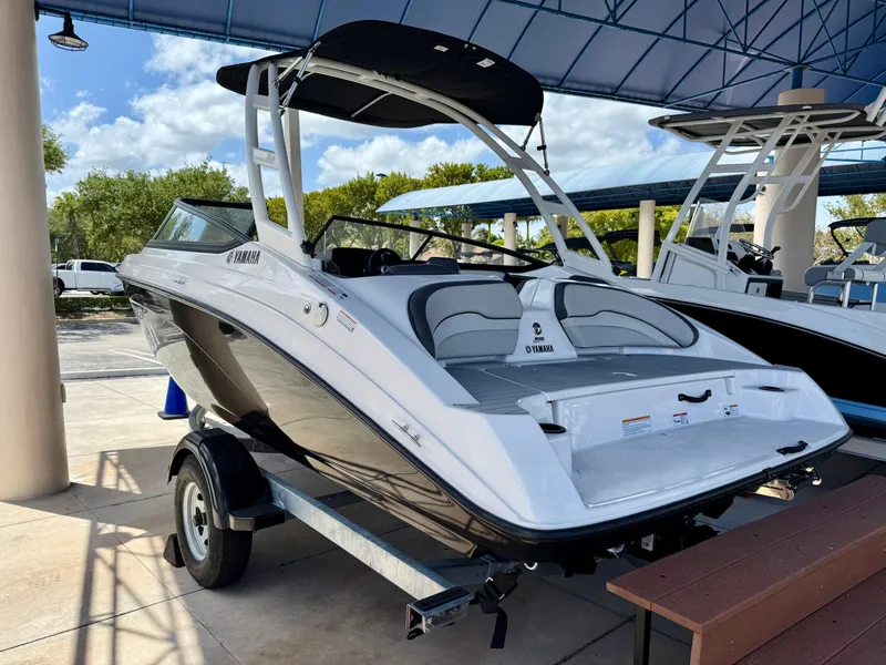 Slide: The Image of 2025 Yamaha Boats AR190 on trailer, sleek design, under a canopy, ready for adventure. - 4