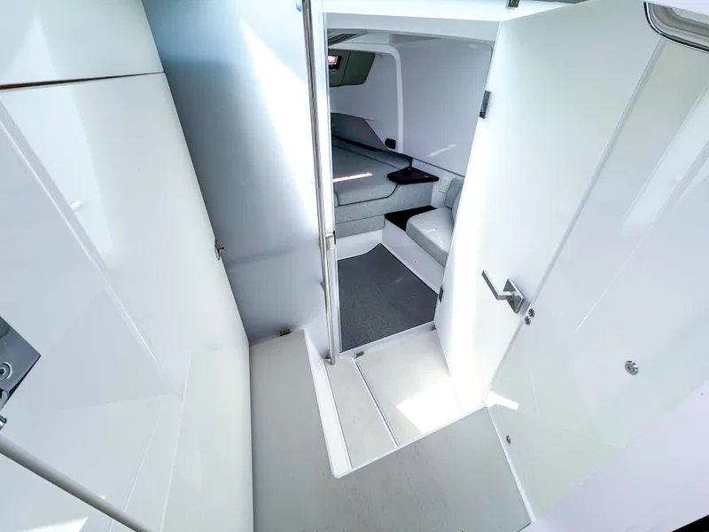 Slide: The Image of 2023 Axopar 37 XC CROSS CABIN interior with modern white and gray design. - 17