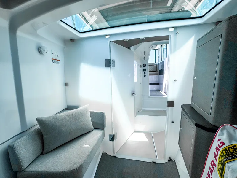 Slide: The Image of 2023 Axopar 37 XC CROSS CABIN interior with modern seating and skylight. - 21