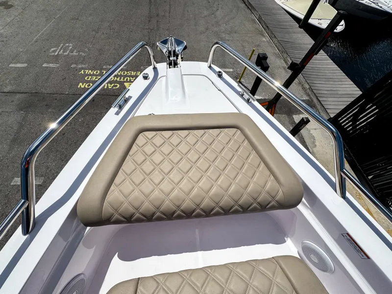 Slide: The Image of 2023 Axopar 37 XC CROSS CABIN bow with diamond-stitched seating and stainless steel railings. - 28