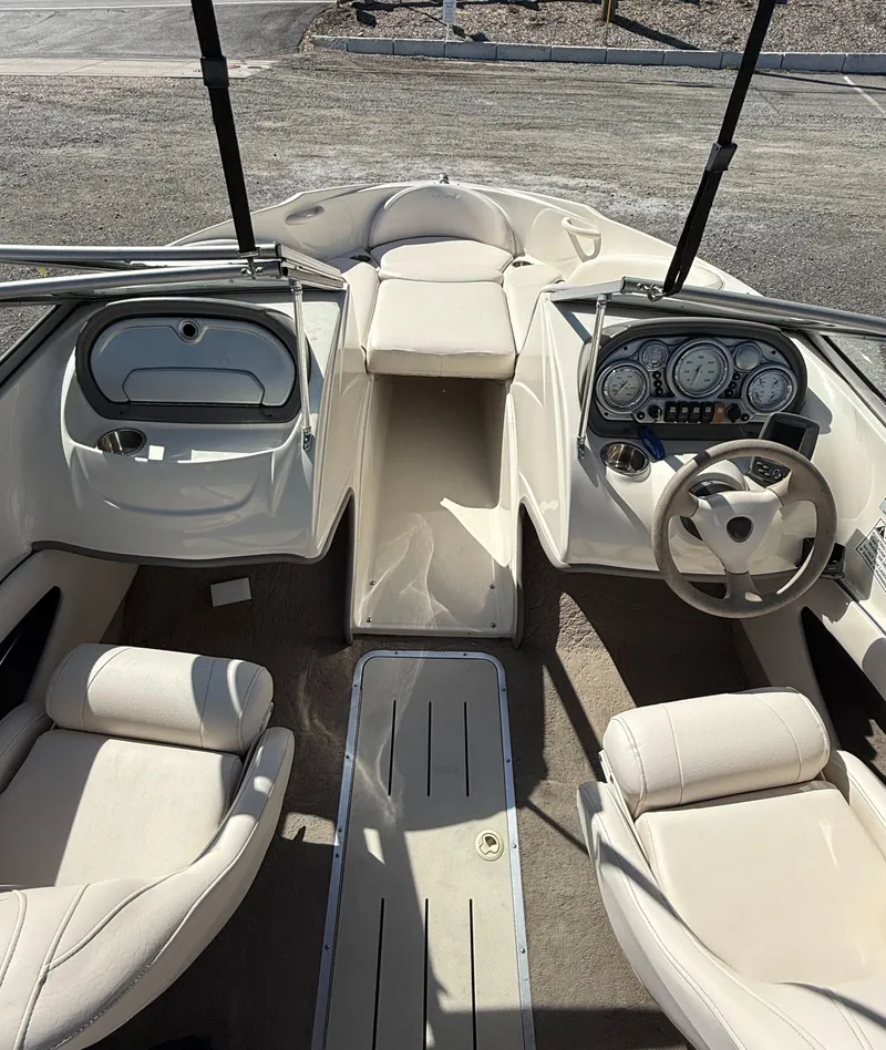 Slide: The Image of 2006 Azure AZ188 boat interior with beige seating and modern dashboard. - 5