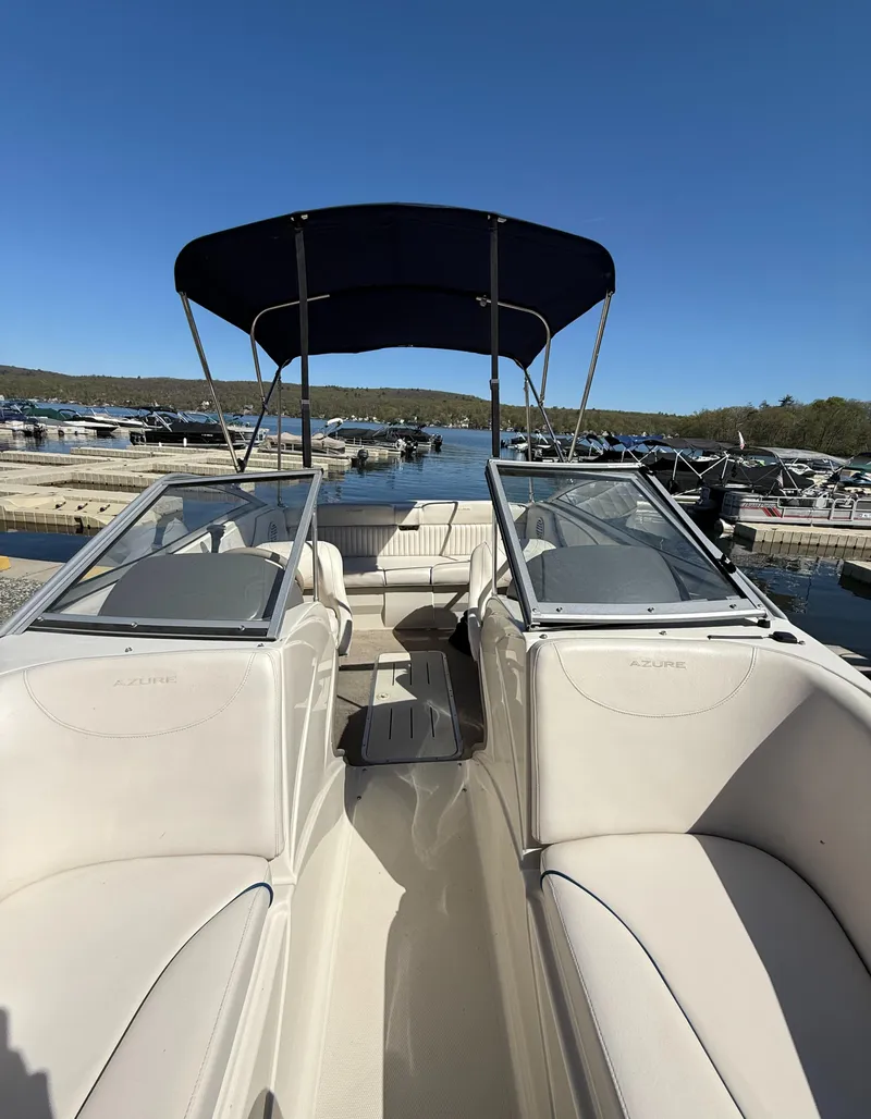 Slide: The Image of 2006 Azure AZ188 boat with canopy docked at marina under clear blue sky. - 8