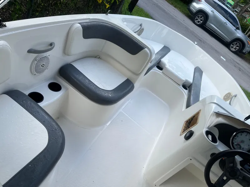 Slide: The Image of 2020 Bayliner Element boat interior with cushioned seating and cup holders. - 2