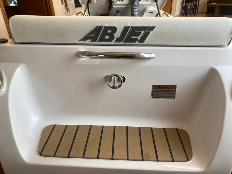 Slide: The Image of 2024 AB Inflatables ABJET 290 boat interior with logo and seating area. - 12
