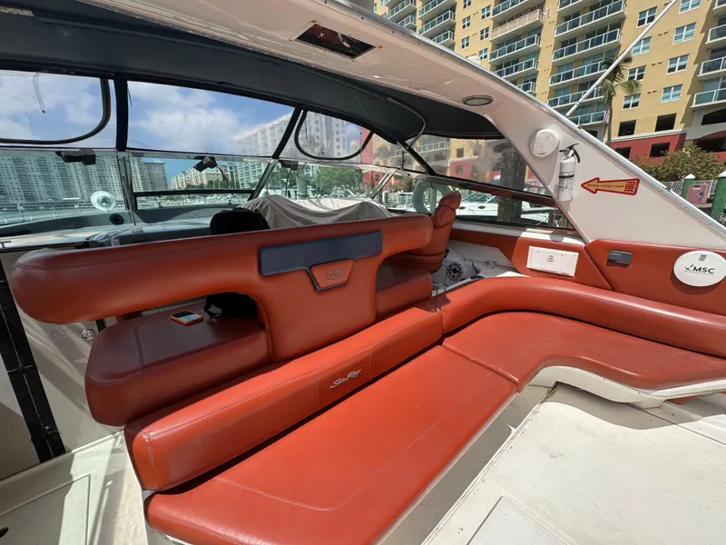 Slide: The Image of 1999 Sea Ray Sundancer 50 interior with red leather seating and cityscape view. - 14