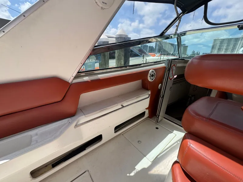 Slide: The Image of 1999 Sea Ray Sundancer 50 interior with red seating and open cabin door. - 17