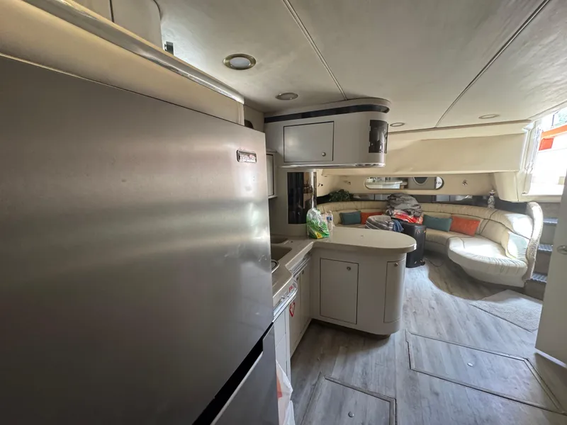 Slide: The Image of Interior of 1999 Sea Ray Sundancer 50 yacht with modern kitchen and cozy seating area. - 29