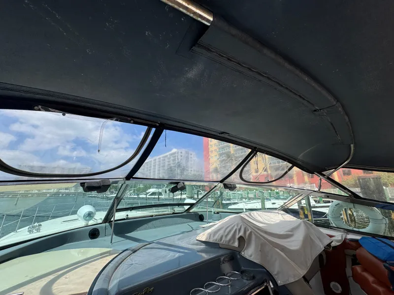 Slide: The Image of 1999 Sea Ray Sundancer 50 cockpit with covered seating and marina view. - 31