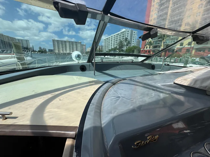 Slide: The Image of 1999 Sea Ray Sundancer 50 yacht with cityscape and marina in the background. - 34