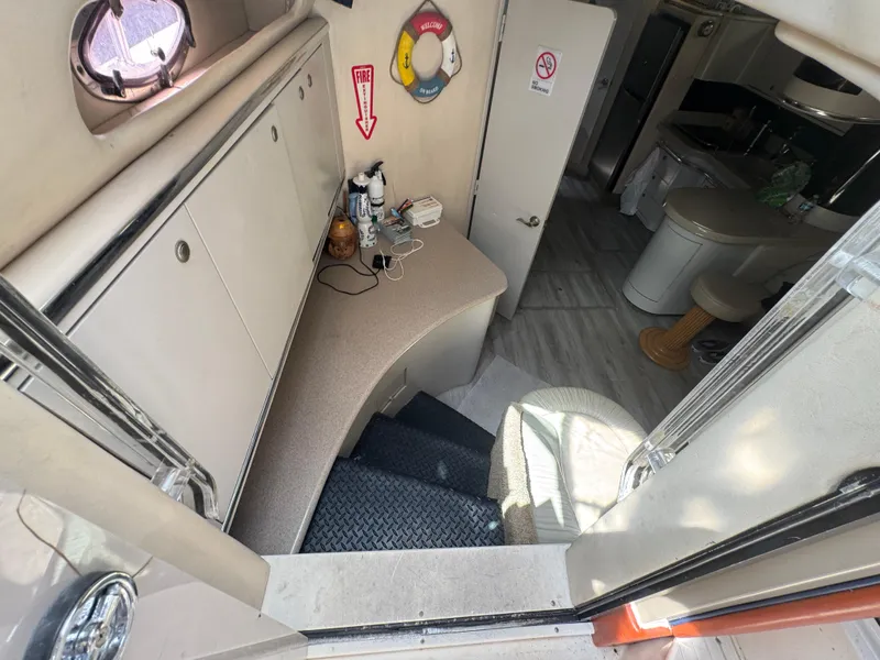 Slide: The Image of Interior of 1999 Sea Ray Sundancer 50 yacht, featuring stairs and compact kitchenette. - 35