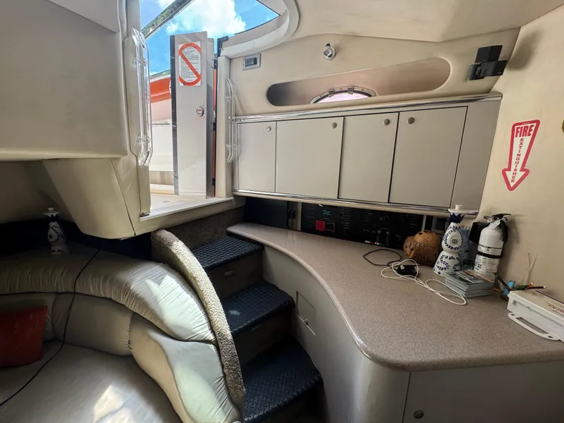Slide: The Image of 1999 Sea Ray Sundancer 50 interior with cabinets, stairs, and safety equipment. - 36
