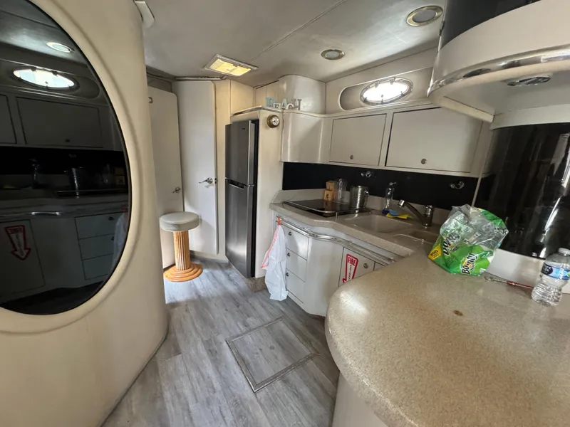 Slide: The Image of Interior of 1999 Sea Ray Sundancer 50 yacht, featuring a compact kitchen area. - 37
