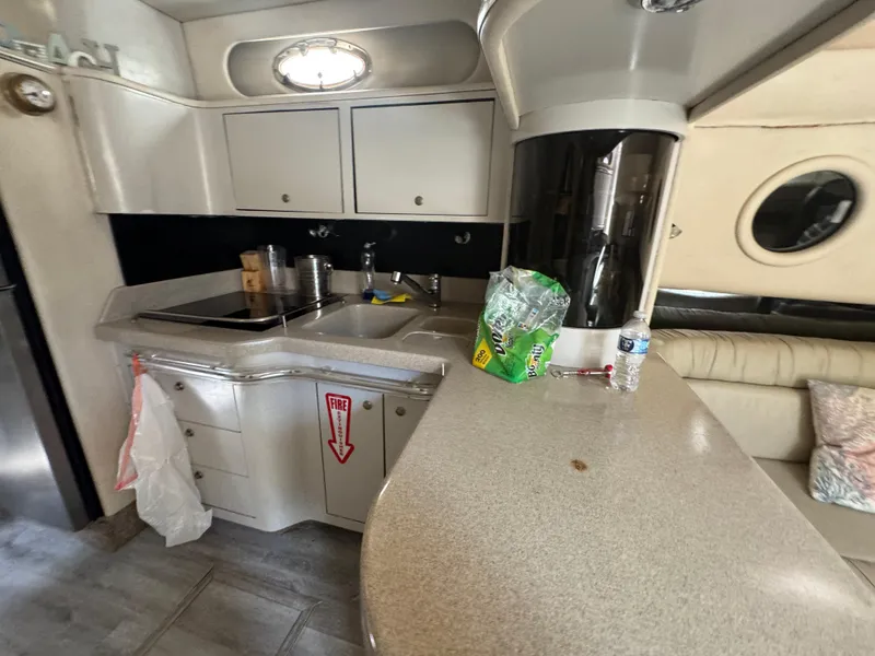 Slide: The Image of Interior of 1999 Sea Ray Sundancer 50 yacht, featuring kitchen and seating area. - 38