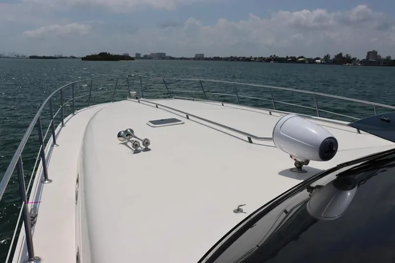 Slide: The Image of 1999 Sea Ray Sundancer 50 yacht deck on open water, clear sky, and distant shoreline. - 4