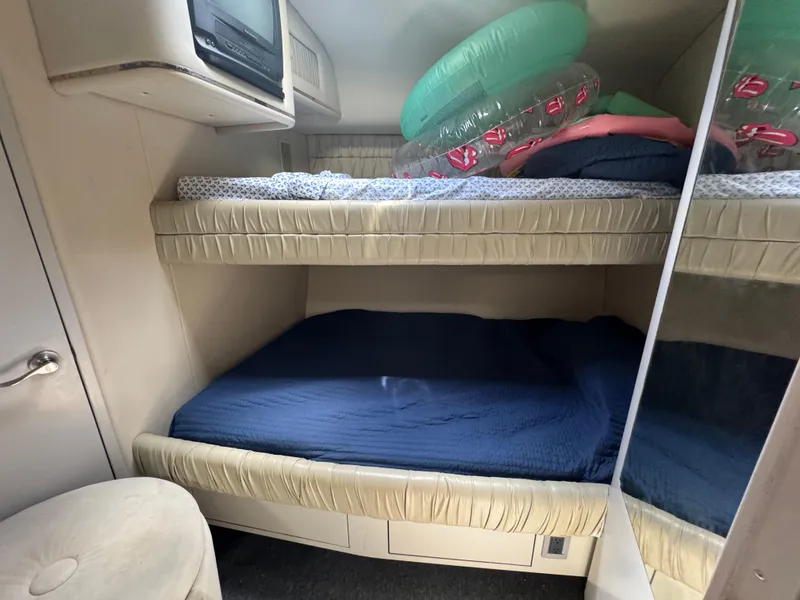 Slide: The Image of 1999 Sea Ray Sundancer 50 cabin with bunk beds and inflatable pool toys. - 41