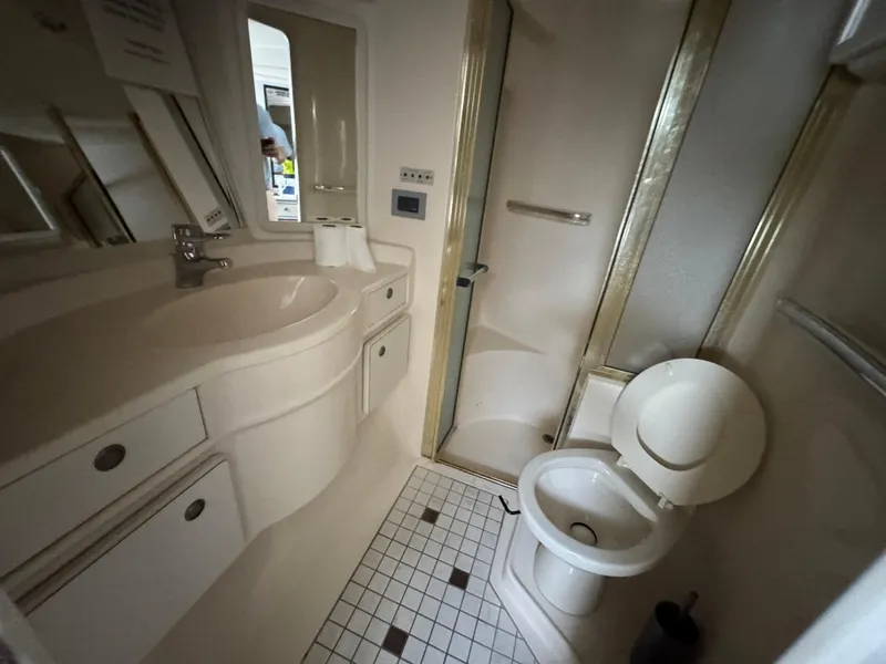 Slide: The Image of Bathroom interior of 1999 Sea Ray Sundancer 50 yacht, featuring shower, sink, and toilet. - 47