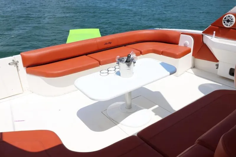 Slide: The Image of 1999 Sea Ray Sundancer 50 yacht with red seating and table on deck. - 5