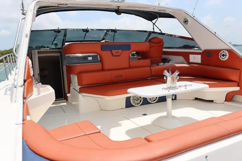 Slide: The Image of Luxurious 1999 Sea Ray Sundancer 50 yacht interior with orange seating and a white table. - 7