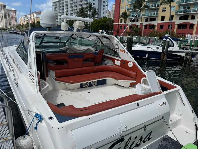 Slide: The Image of 1999 Sea Ray Sundancer 50 yacht docked, featuring spacious seating and modern amenities. - 8