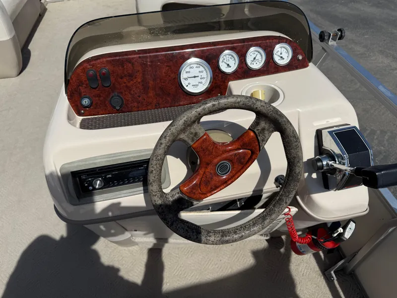 Slide: The Image of Steering console of a 2005 Sun Tracker Party Barge 21 with gauges and controls. - 10