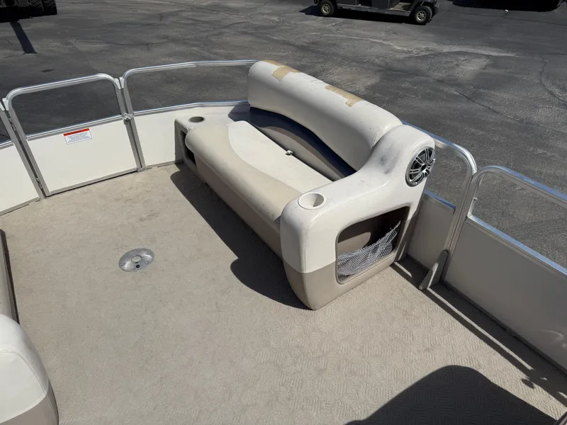 Slide: The Image of 2005 Sun Tracker Party Barge 21 pontoon boat seating area with beige upholstery. - 12