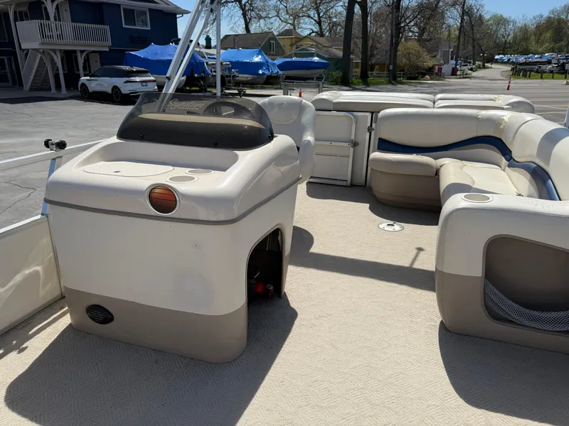 Slide: The Image of 2005 Sun Tracker Party Barge 21 interior with seating and control console, docked at marina. - 13