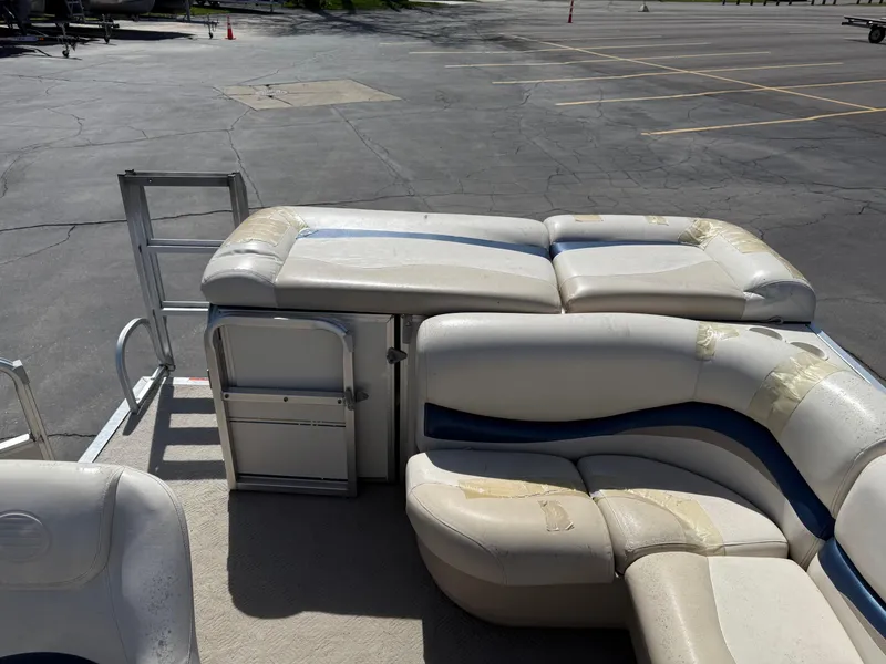 Slide: The Image of 2005 Sun Tracker Party Barge 21 pontoon boat interior with seating and storage. - 16