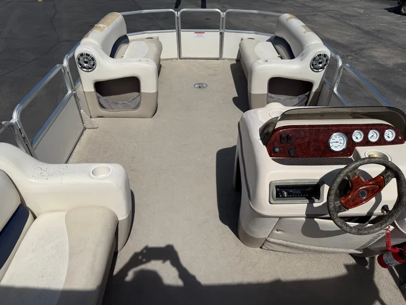 Slide: The Image of 2005 Sun Tracker Party Barge 21 interior with seating and steering console. - 17