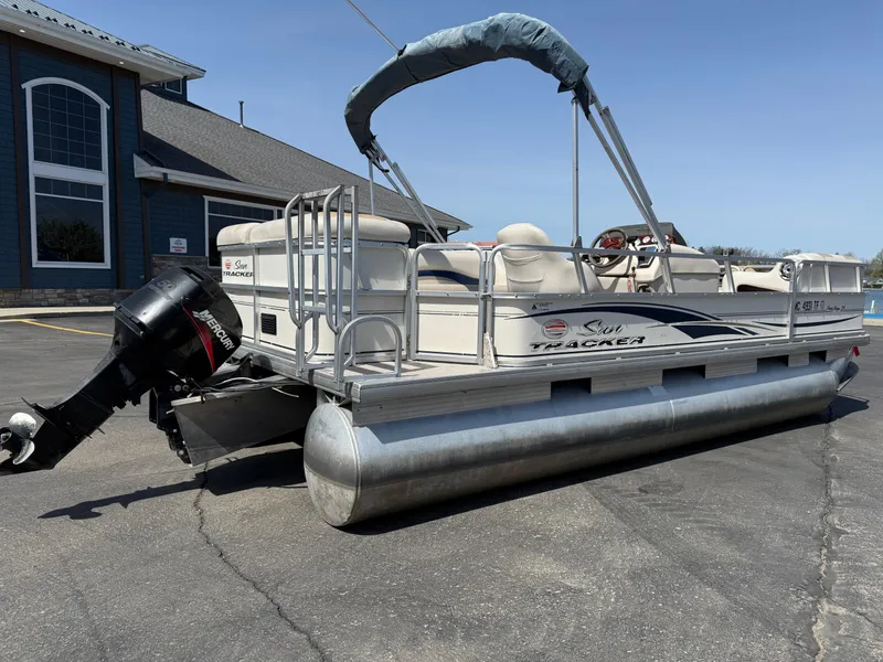 Slide: The Image of 2005 Sun Tracker Party Barge 21 pontoon boat parked on pavement. - 5