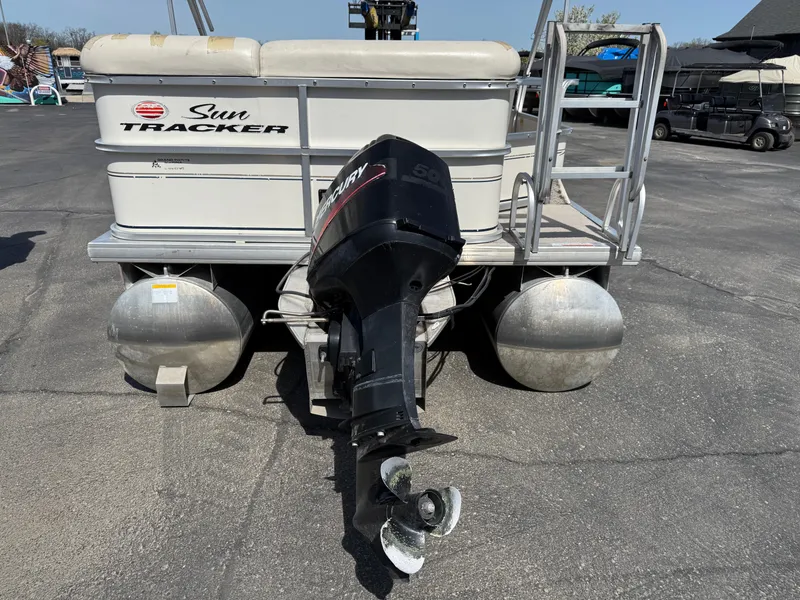 Slide: The Image of 2005 Sun Tracker Party Barge 21 pontoon boat with outboard motor, parked on pavement. - 6