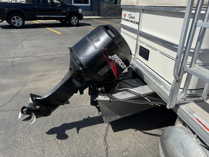 Slide: The Image of 2005 Sun Tracker Party Barge 21 with Mercury outboard motor in parking lot. - 7
