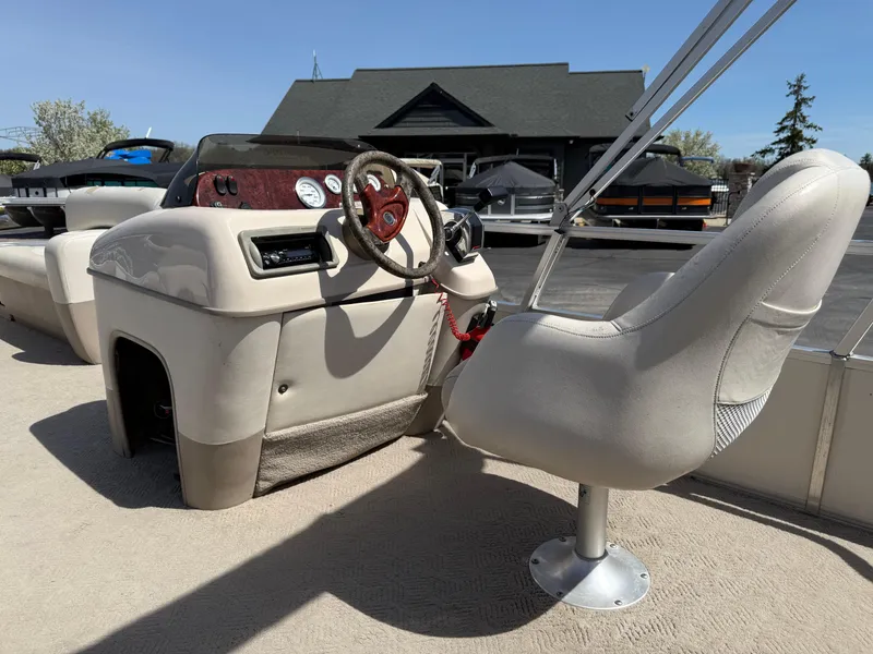 Slide: The Image of 2005 Sun Tracker Party Barge 21 interior with steering wheel and captain's chair. - 8