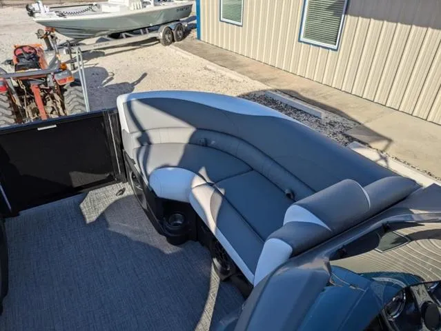 Slide: The Image of 2025 Avalon LSZ Quad Lounge Switch 2385 interior with gray seating, parked near a building. - 10