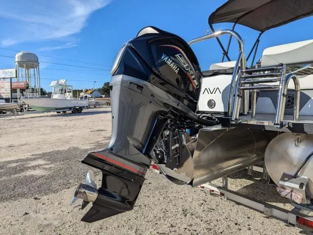 Slide: The Image of 2025 Avalon LSZ Quad Lounge Switch 2385 with Yamaha outboard motor, parked on a trailer. - 20