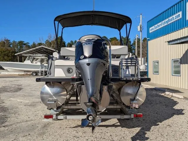Slide: The Image of 2025 Avalon LSZ Quad Lounge Switch 2385 pontoon boat with powerful outboard motor. - 6
