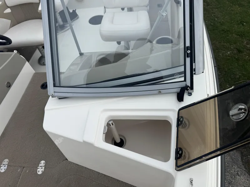 Slide: The Image of 2011 FinCraft 1850 boat interior with open storage compartment and seating. - 11