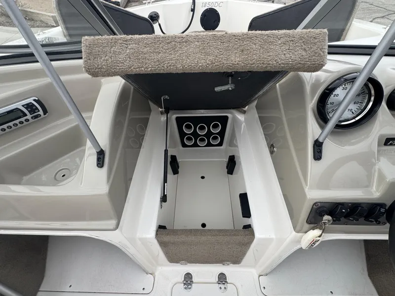 Slide: The Image of Interior of a 2011 FinCraft 1850 boat showing dashboard and seating area. - 13