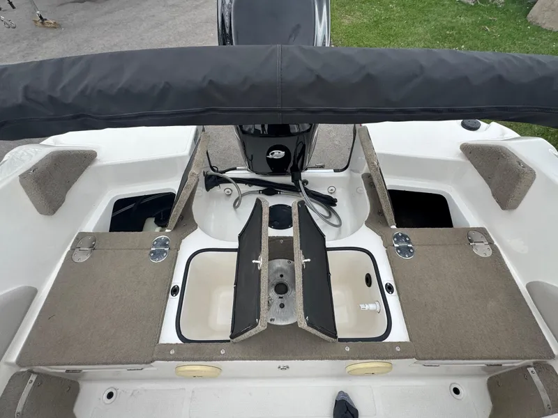 Slide: The Image of FinCraft 1850 boat interior, 2011 model, featuring storage compartments and seating area. - 18