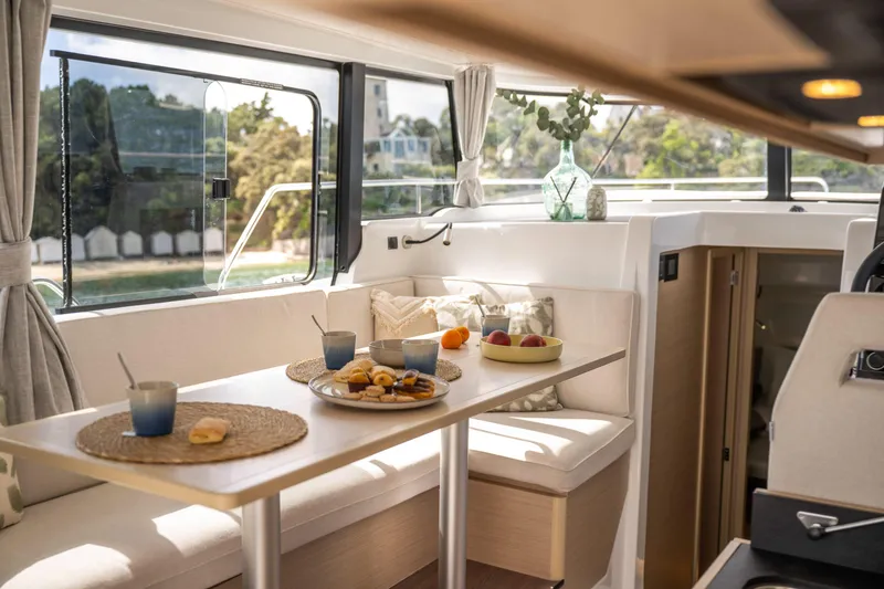 Slide: The Image of Interior of 2025 Delphia D10 Sedan yacht with elegant dining setup. - 12